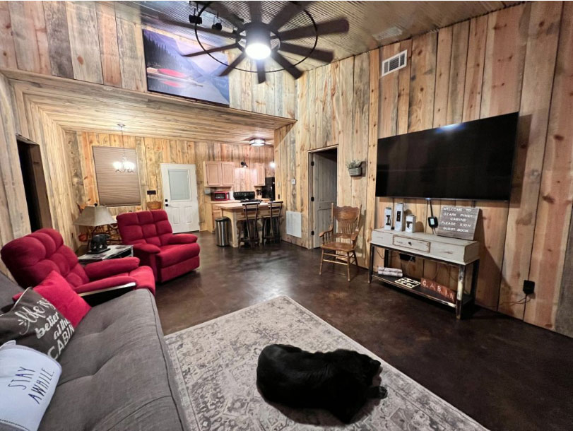 cabin living room with lab sleeping on the rug<br />
